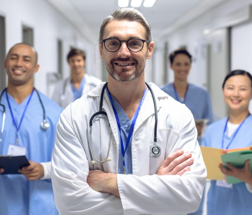 diverse-medical-team-of-doctors-looking-at-camera-while-holding-clipboard-and-medical-files.jpg